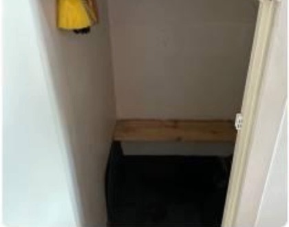 New boiler in a bare cupboard before