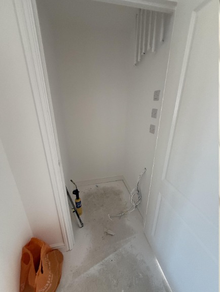 Cylinder in a bare cupboard before
